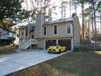 Two-story house with attached two-car garage and a landscaped yard at 3085 Everson Ct, Snellville, GA 30039