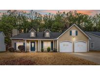 Charming single-Gathering home with a well-maintained lawn and attached two-car garage at 5732 Village Loop, Fairburn, GA 30213