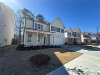 Two-story house with white siding, gray shutters, and a two-car garage at 799 River Gardens Se Dr, Atlanta, GA 30354