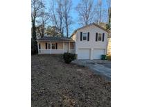 Ranch style home with attached garage and covered porch at 2145 Marbut Farns Ct, Lithonia, GA 30058