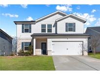 Two-story house with white siding, gray shutters, and a two-car garage at 4839 Dufour Dr, Lilburn, GA 30047