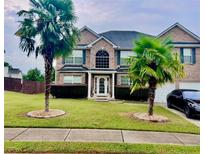 Brick two-story house with palm trees and a large yard at 160 Oak Manor Dr, Covington, GA 30016