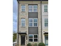 Three-story brick townhome with modern design and neutral color palette at 2651 Stream Nw Ter, Atlanta, GA 30318