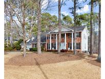 Charming two-story brick home with white columns and a well-manicured front yard at 1579 Howell Highlands Dr, Stone Mountain, GA 30087