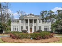 Stately white home featuring a columned entrance and manicured landscaping at 7 W Andrews Nw Dr, Atlanta, GA 30305