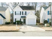 Two-story house with attached garage and manicured lawn at 30 Springbottom Dr, Lawrenceville, GA 30046