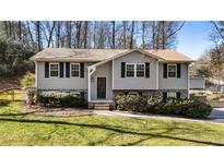 Gray house with brick accents, landscaping, and a spacious yard at 3001 Scott Rd, Marietta, GA 30066