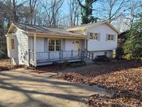 Charming two-story home with a cozy front porch and a classic design with a mature landscape at 3667 Humphries Hill Rd, Austell, GA 30106