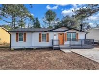 Newly renovated single story home with modern gray accents and wood shutters at 2918 Fields Dr, Lithonia, GA 30038