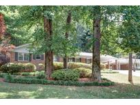 Brick ranch home nestled among mature trees, offering curb appeal and a serene setting at 3449 Palace Ct, Tucker, GA 30084