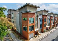 Modern townhomes featuring a mix of brick and siding exteriors with attached garages at 958 Moda Dr, Atlanta, GA 30316