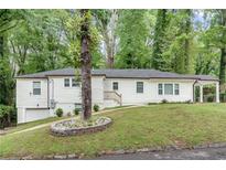 Charming white ranch home with a spacious yard and carport at 2705 Baker Ridge Nw Dr, Atlanta, GA 30318