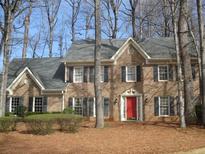 Traditional brick home featuring manicured landscaping and mature trees at 3483 Princeton Corners Dr, Marietta, GA 30062