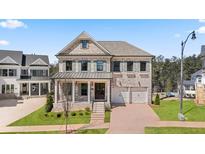 Charming two-story home with brick facade, lush lawn, and two-car garage at 5247 Flannery Chase Sw, Powder Springs, GA 30127
