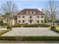 Stunning two-story home with a symmetrical facade, beautiful landscaping and a circular gravel driveway at 2631 Habersham Nw Rd, Atlanta, GA 30305