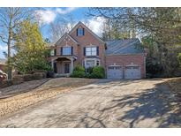 Brick home with three-car garage and long driveway at 1325 Cameron Glen Dr, Marietta, GA 30062