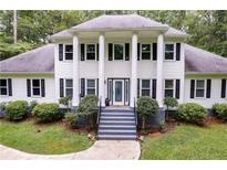 Two-story house with white siding, gray steps, and landscaping at 212 Teepee Trl, Whitesburg, GA 30185