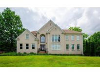 Brick two-story house with a large front yard and mature trees at 2120 Shaffer Rd, Cumming, GA 30041