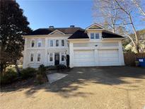 Two story home with a two car garage and a traditional, symmetrical facade at 1901 Shelburne Cv, Marietta, GA 30068