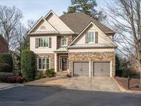 Two-story house with stone accents and a three-car garage at 2012 Mendenhall Cir, Atlanta, GA 30341