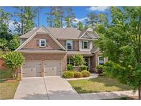 Beautiful two-story brick home with a two-car garage and manicured landscaping at 231 Haney Rd, Woodstock, GA 30188