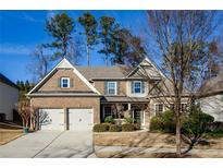 Two-story brick home with a large front yard and two-car garage at 231 Haney Rd, Woodstock, GA 30188