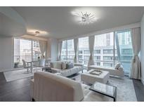 Spacious living room with floor-to-ceiling windows and city views at 20 10Th Nw St # 704, Atlanta, GA 30309