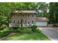 Two-story house with deck, attached garage, and landscaped yard at 4848 Green Forest Nw Ct, Acworth, GA 30102