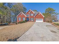 Brick house with 2-car garage and landscaped yard at 2255 Pinehaven Ct, Grayson, GA 30017