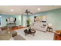 Bright living room featuring hardwood floors, modern decor, and a ceiling fan for added comfort at 64 Devon Ln, Avondale Estates, GA 30002