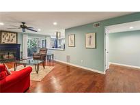 Bright living room features hardwood floors, fireplace, and access to a balcony at 64 Devon Ln, Avondale Estates, GA 30002