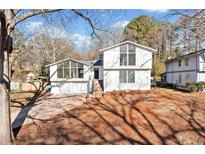 Stunning renovated home with modern exterior and landscaped yard at 4119 Valley Brook Rd, Snellville, GA 30039