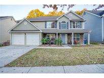 Charming two-story home with a two-car garage, stone accents, covered porch and manicured front yard at 2853 Austin Ridge Dr, Dacula, GA 30019
