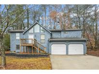 Two-story house with gray siding, attached two-car garage, and deck at 4006 Maxanne Nw Dr, Kennesaw, GA 30144