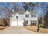 Two-story house with gray siding, white trim, and a two-car garage at 11145 Glenbarr Dr, Johns Creek, GA 30097