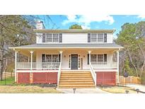 Charming two-story home with inviting front porch and well-maintained lawn at 1867 Falcon Wood Ne Dr, Marietta, GA 30066