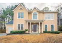 Two-story house with stone accents and landscaping at 1650 Willow Way, Woodstock, GA 30188