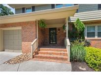 Brick front entrance with steps, porch, and landscaping at 647 Shannon Green Cir, Mableton, GA 30126