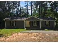 Ranch style home with gray siding, and a spacious front yard at 387 Lassetter Rd, Sharpsburg, GA 30277