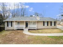 Charming ranch-style home featuring a welcoming front porch and traditional design at 4196 Jami Ln, Snellville, GA 30039