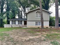 Brick house with a large front yard and mature trees at 4048 Rainbow Dr, Decatur, GA 30034