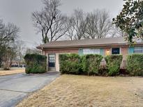 Charming brick home with a well-manicured front yard and covered entry at 1581 Wesley Nw Way, Conyers, GA 30012