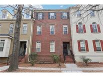 Charming three-story brick townhouse with black shutters and well-maintained landscaping at 2732 Wander Ln, Alpharetta, GA 30022