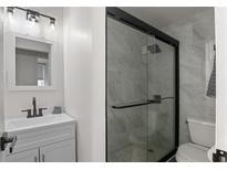 Modern bathroom with a large glass shower and white vanity at 300 Peachtree St # 24-I, Atlanta, GA 30305