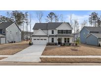 Two-story house with white siding, gray roof, and a driveway at 8 Tallulah Trl, Sharpsburg, GA 30277