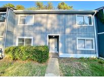 Inviting exterior of a two-story townhome with landscaping at 927 Pine Oak Trl, Austell, GA 30168