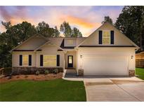 Two story house with light beige vinyl siding, a gray roof, and a two-car garage at 105 Eryn Ter, Covington, GA 30014