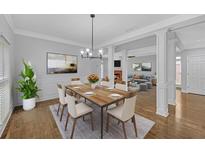 Bright dining room with hardwood floors, modern lighting and open to living room at 1125 Blackshear Dr, Decatur, GA 30033