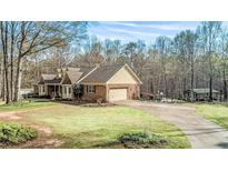 Brick ranch house with attached garage and large yard at 380 Stone Rd, Mcdonough, GA 30253
