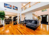 Bright living room with hardwood floors, large windows, and an open floor plan at 1045 Paper Creek Dr, Lawrenceville, GA 30046